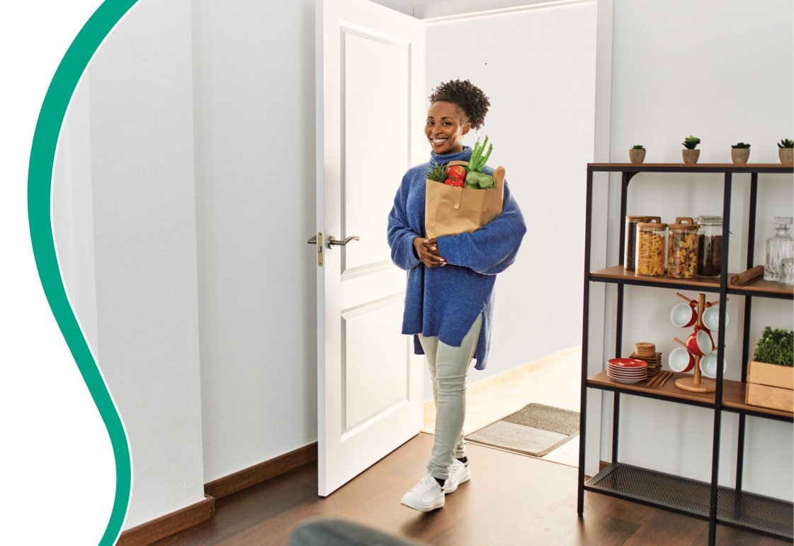 Female walking into a room with groceries; not an actual patient